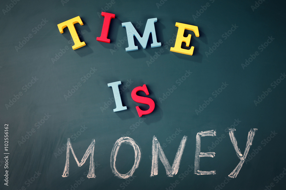 Time is money concept on a blackboard background Time is money concept on a blackboard background