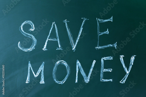 Save money concept on a blackboard background