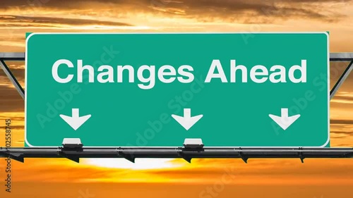 Changes ahead highway sign with time lapse sunset clouds.