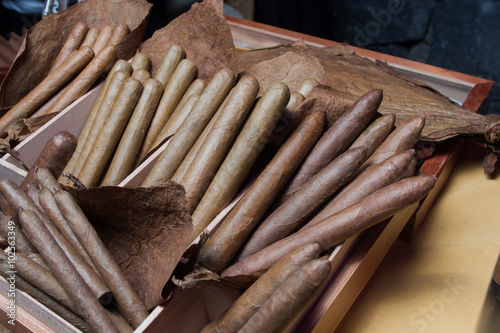 stack of hand made canarian cuban cigars parejos on wooden table photo