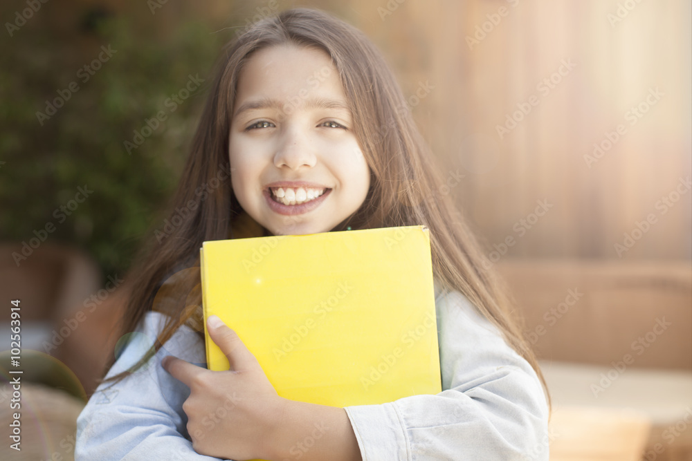 smiling little student girl with many books at school smiling little student girl with many books at school