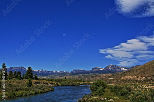 Du Noir Creek just outside of Dubois Wyoming with Breccia Cliffs and Breccia Peak in the background on Togwotee Pass Absaroka Mountains during the summer in Wyoming USA with wispy clouds over head.  photo