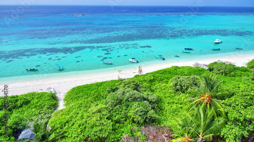 Shoreline of a tropical island in the Maldives and view of the I