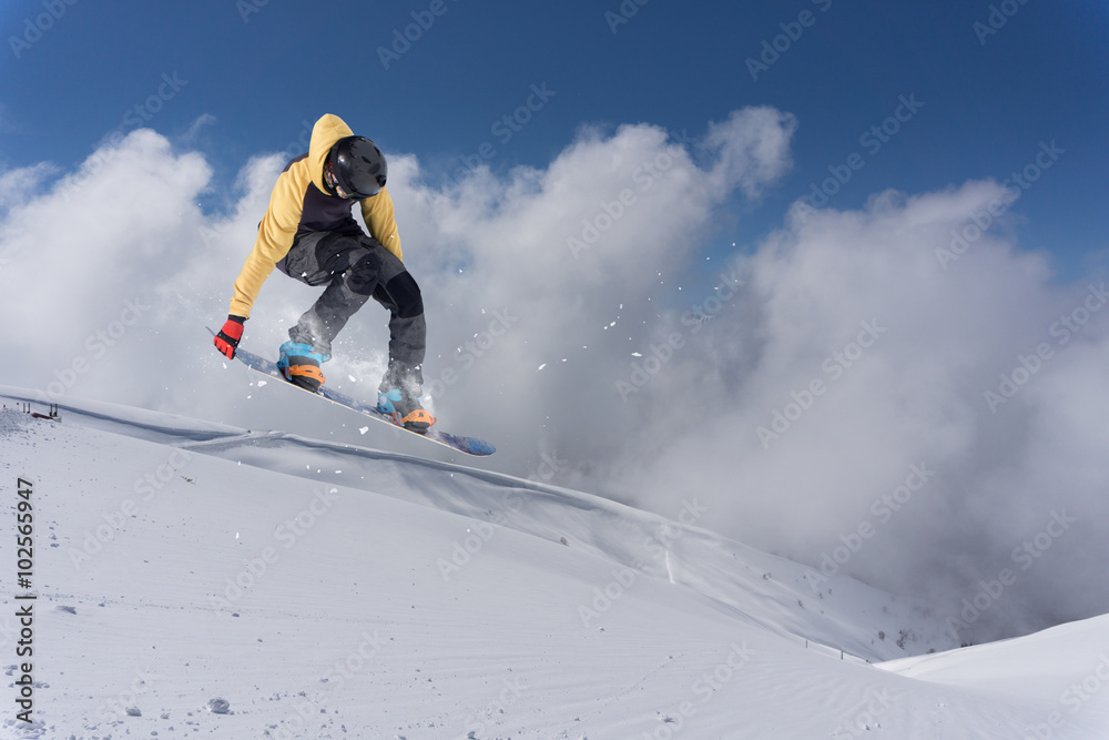 Flying snowboarder on mountains. Extreme sport. Flying snowboarder on mountains. Extreme sport.