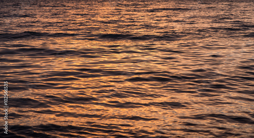 Sea surface with reflection at sunset. Selective focus.