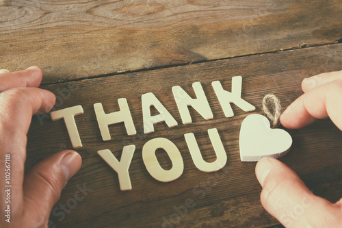 Konstfotografi thank you letters and men's hand over wooden table