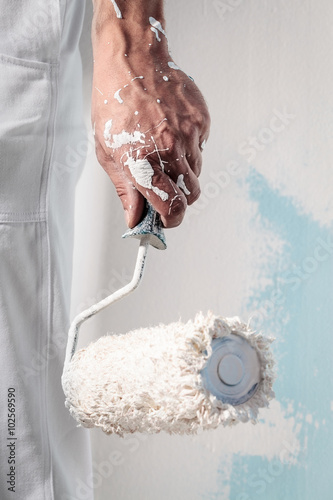 Workman Hand holding Dirty Paintroller