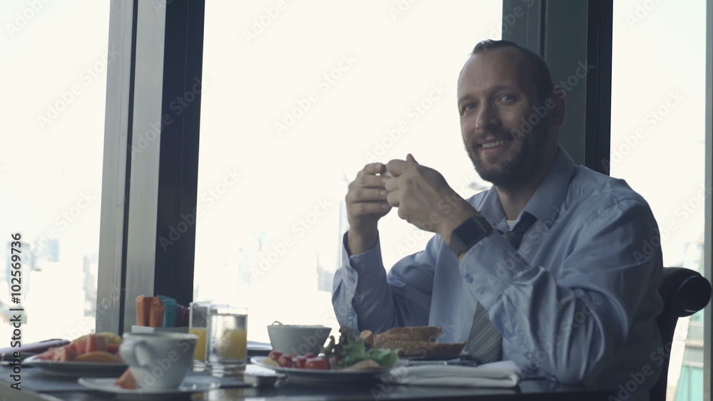 Portrait of happy businessman during breakfast in restaurant
Portrait of happy businessman during breakfast in restaurant