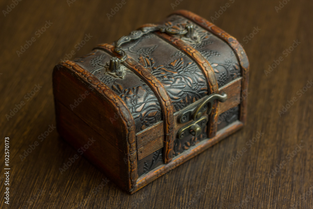 closed treasure chest on wooden table closed treasure chest on wooden table