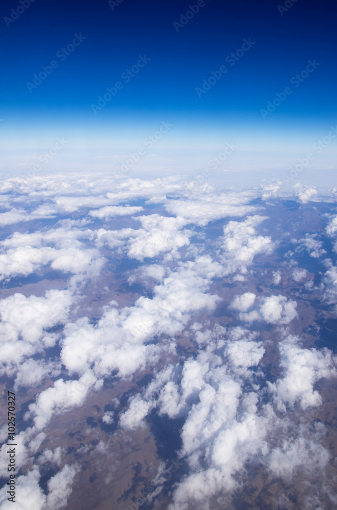 Blue sky background with tiny clouds