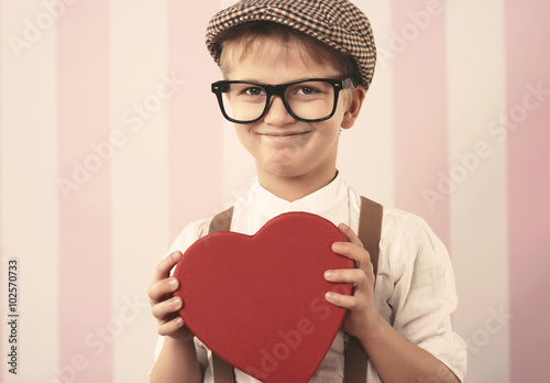 Portrait of cute little boy with Valentine's gift