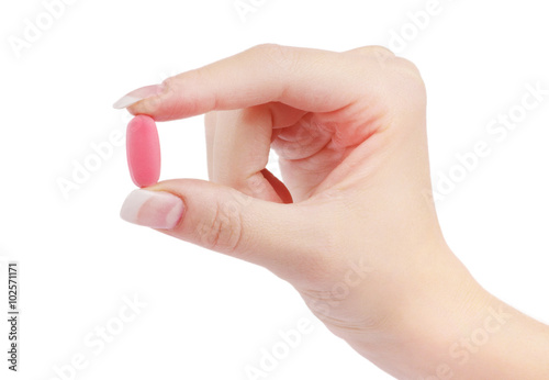 close up round white pill in hand