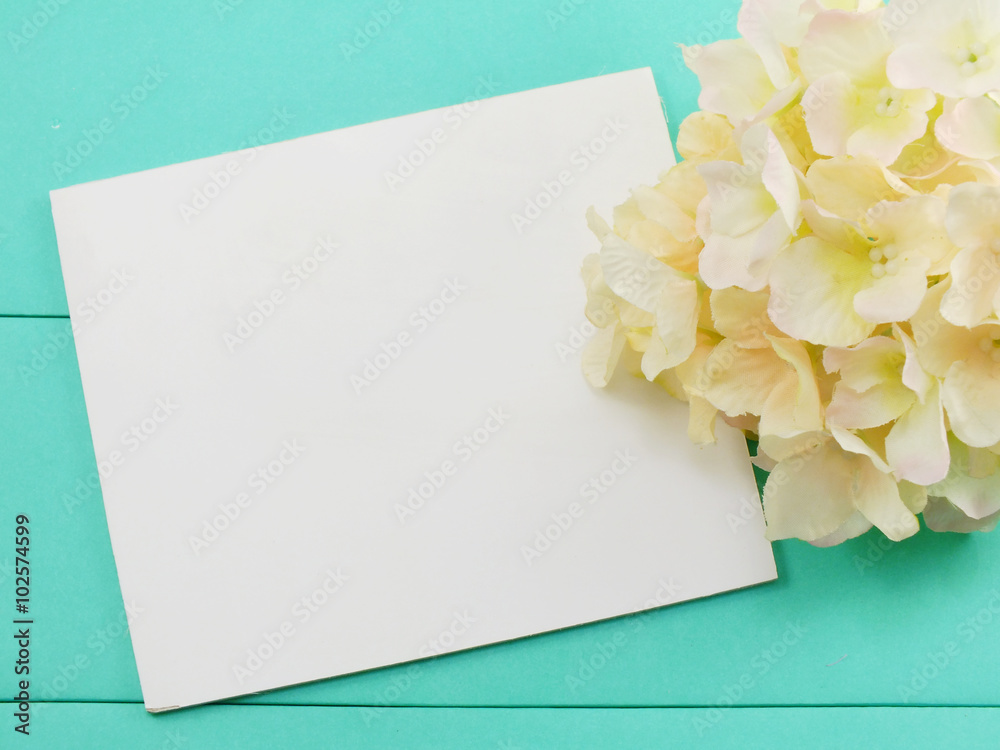 white card and artificial flower valentines day on green background white card and artificial flower valentines day on green background