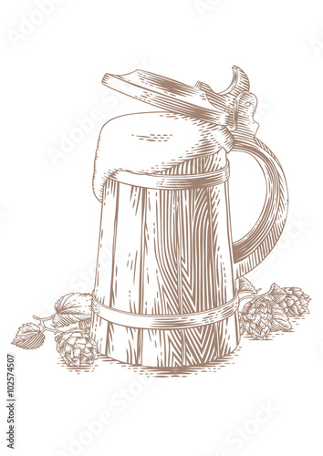 Wooden mug with beer and hops