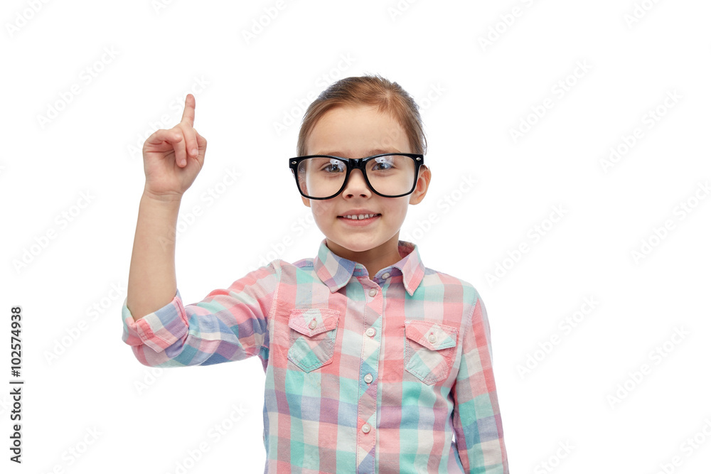 happy little girl in eyeglasses pointing finger up happy little girl in eyeglasses pointing finger up