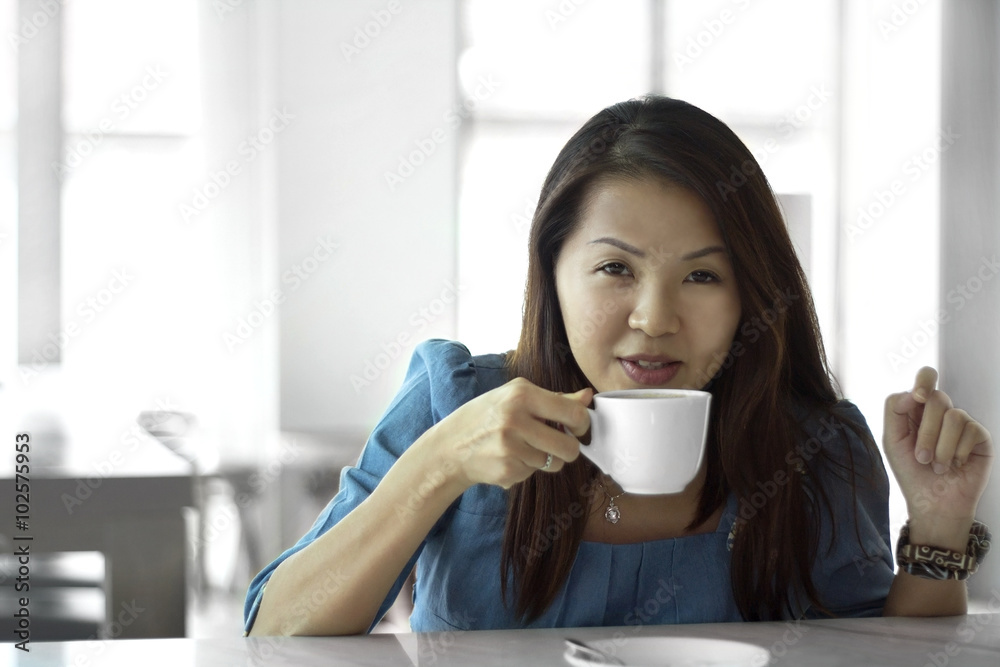 Asian female beautiful women portraits drink coffee cup, chinese girl relax life style in the cafe Asian female beautiful women portraits drink coffee cup, chinese girl relax life style in the cafe