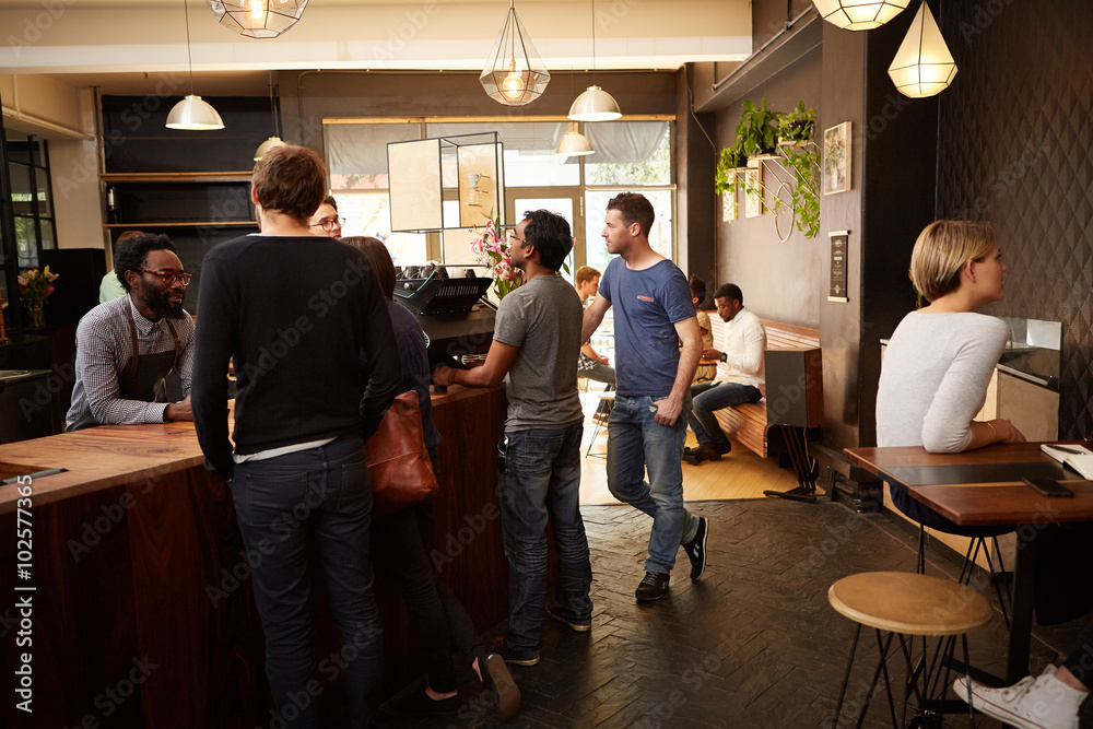People standing at the counter of a modern coffee shop People standing at the counter of a modern coffee shop