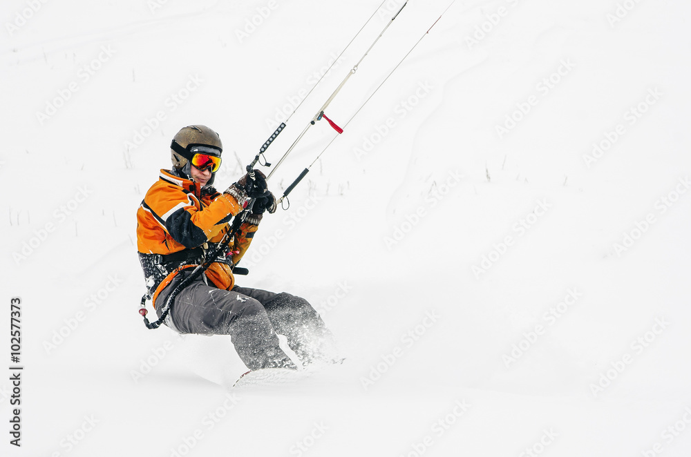 Snowboarder riding a kite