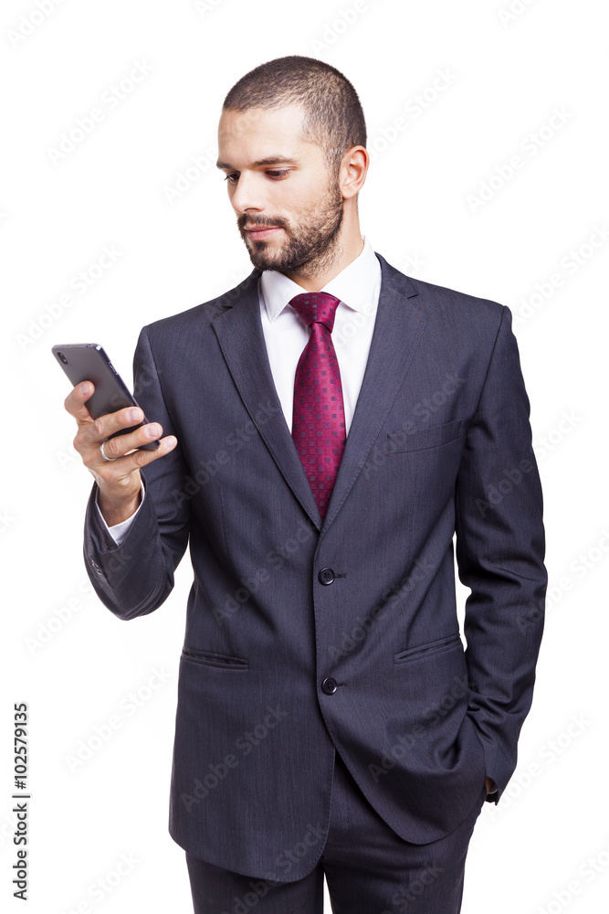 Handsome businessman reading a message on his smartphone, isolat Handsome businessman reading a message on his smartphone, isolat