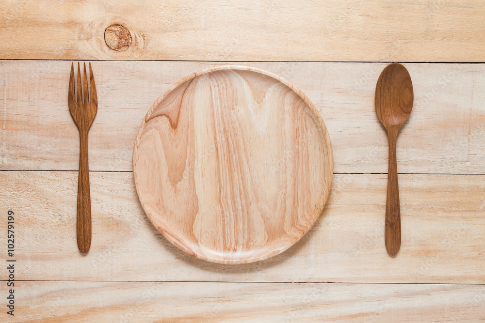 spoon fork and dish wood on wooden table. spoon fork and dish wood on wooden table.