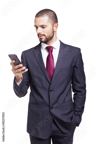 Handsome businessman reading a message on his smartphone, isolat © cristovao31