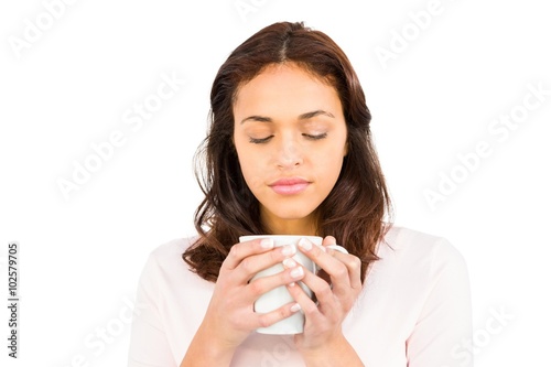 Woman with eyes closed holding mug