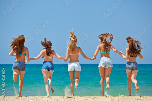 Group of relaxing teenager people on the beach