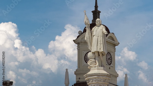 Monument to explorer Christopher Columbus and tower with watch on the Columbus square timelapse hyperlapse.