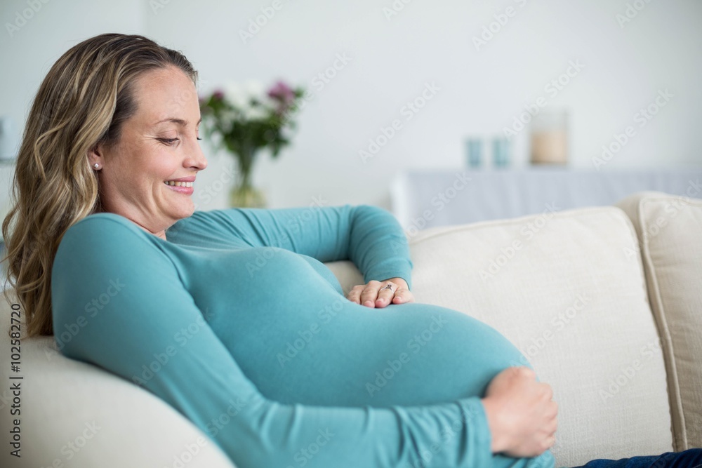 Pregnant woman touching her belly Pregnant woman touching her belly
