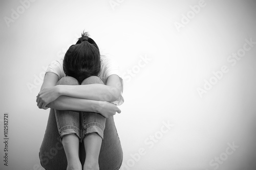 sad woman hug her knee and cry (monochrome)