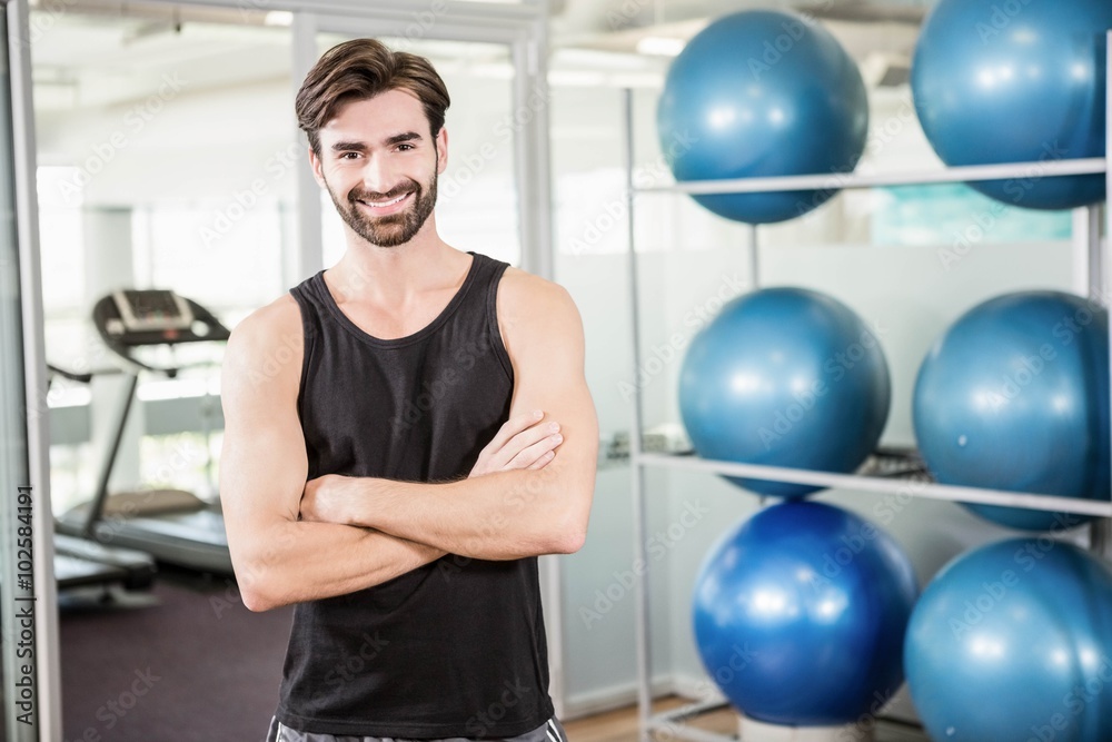 Smiling man standing with arms crossed Smiling man standing with arms crossed