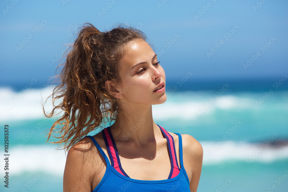 Beautiful young sporty woman at the beach