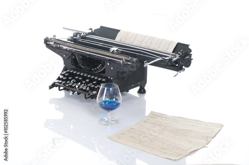 Fotografie Old typewriter on wood on a blue background