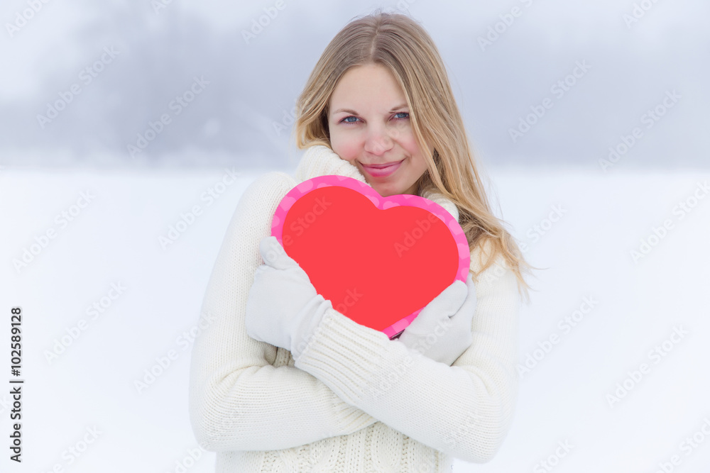 Young nice woman holding red heart and delight about love. Valentines day. Young nice woman holding red heart and delight about love. Valentines day.