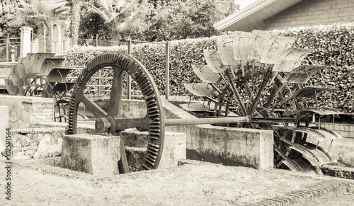 Old iron wheel a watermill. Ruins of a watermill. Effect vintage.
