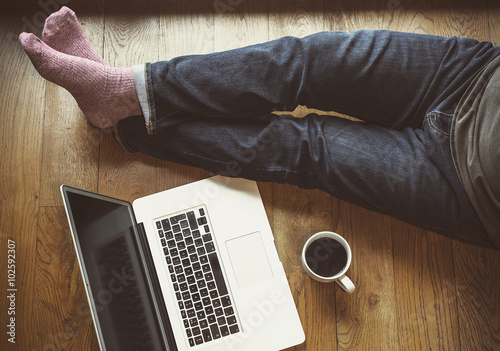 Man sitting on floor with laptop