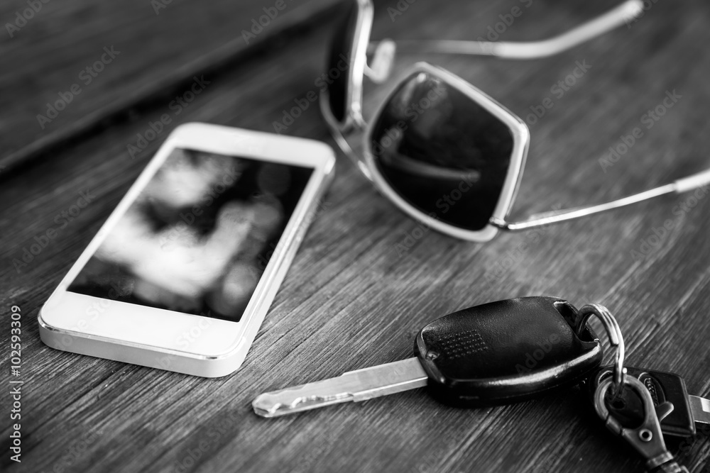 car key with smartphone and sunglasses