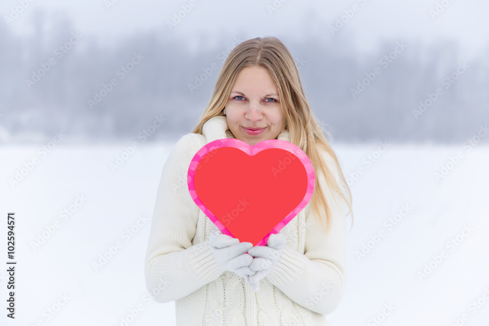 Young nice woman holding red heart and delights about love. Valentines day. Young nice woman holding red heart and delights about love. Valentines day.