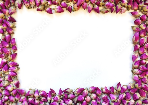 Border frame of romantic dried pink rose buds © eqroy