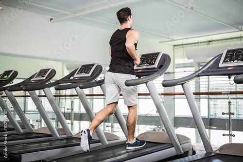 Fit man running on treadmill