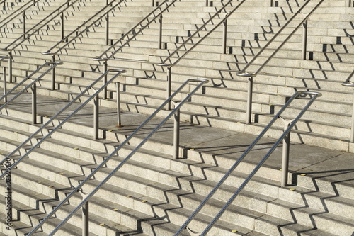 Canvas Print Large stairways with metal handrails and shadows