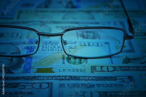Glasses on dollar money, financial and business concept