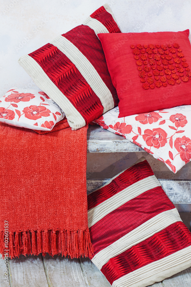 Stack of decorative red pillows of different size, interior decoration ideas