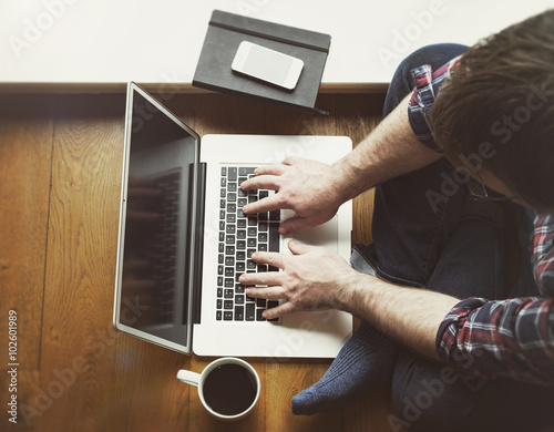 Man sitting on floor with laptop