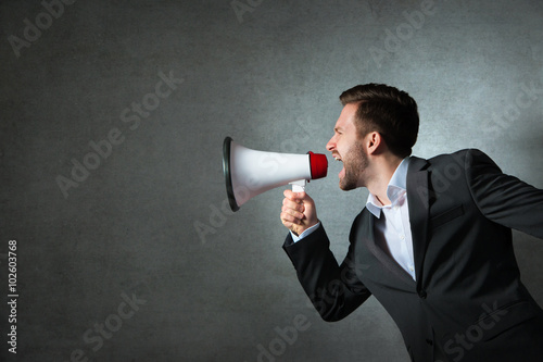 Young businessman with a megaphone