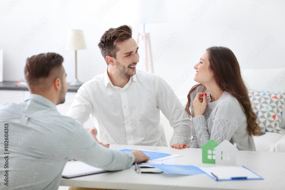 Happy family with estate agent, in bright office Happy family with estate agent, in bright office