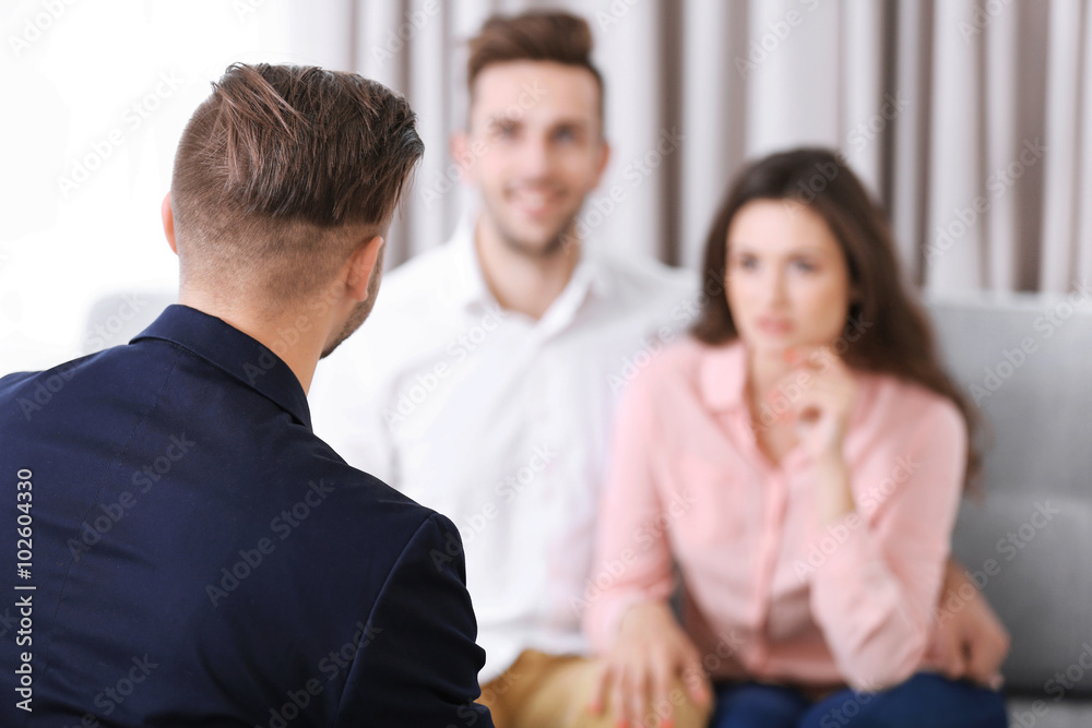 Estate agent meeting with happy couple, on light background Estate agent meeting with happy couple, on light background