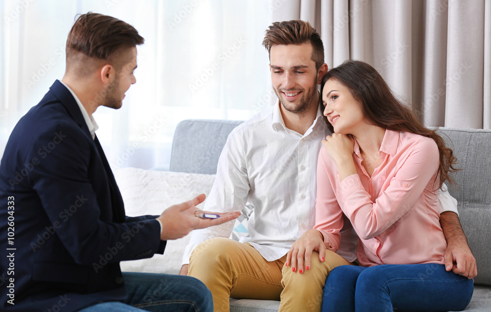 Estate agent meeting with happy couple, on light background Estate agent meeting with happy couple, on light background
