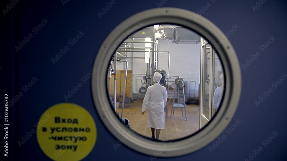 A woman in a lab coat is coming into a secret Russian laboratory. A woman in a lab coat is coming into a secret Russian laboratory.