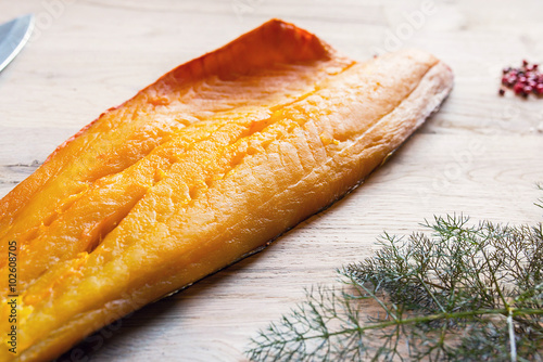 Photos beautiful yellow smoked haddock fish fillet with a branch of fresh dill weed, sa